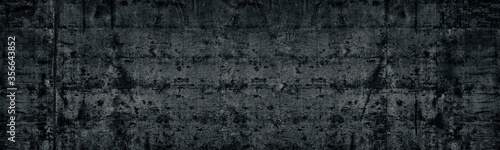 Black old shabby concrete wall wide texture. Aged cement surface. Dark long grunge background