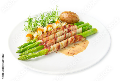 Bacon wrapped asparagus grilled with sasemi sauce and pea sprouts roll in chili  salad black sasemi decorate bake potato chedda cheese side view isolated on white background photo