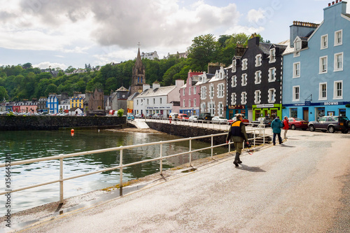 People walking on a street in the harbor of Tobermory in Scotland photo