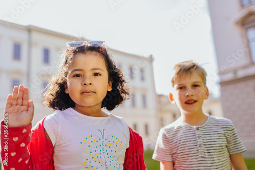 Two friendly dark-skinned and white, children diverse positive boy and girl playing together. Children do not have racism. photo