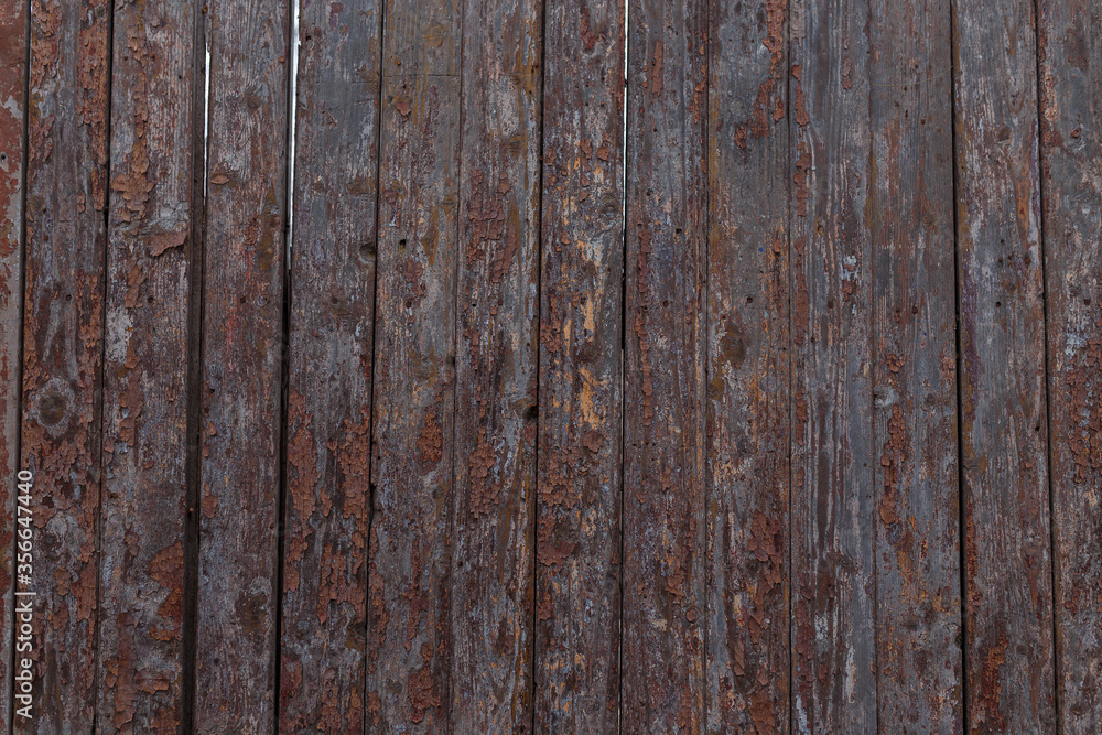 Brown wooden boards or fence texture background or backdrop with old paint Brown wooden boards or fence texture background or backdrop with old paint