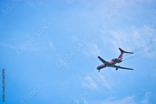 Passenger airliner flying in the blue sky. The concept of vacation  business trip  dream. Commercial aircraft.
