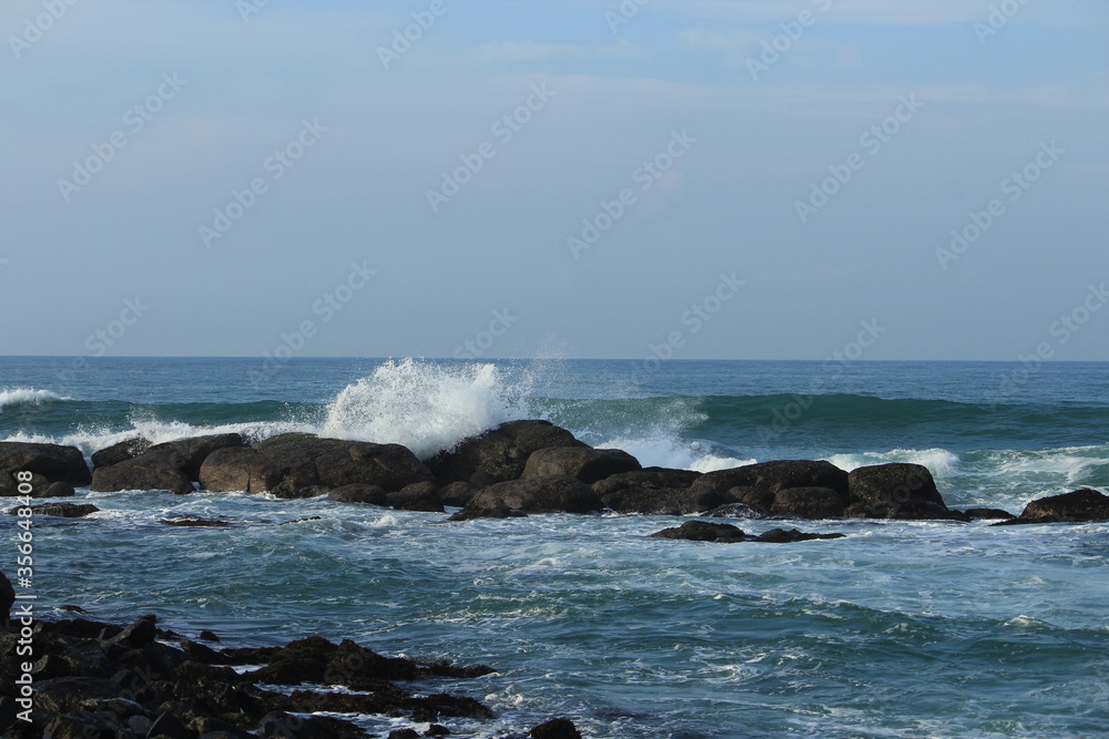 Sea White water waves jumping over the Rocks at Indian Ocean Sea White water waves jumping over the Rocks at Indian Ocean