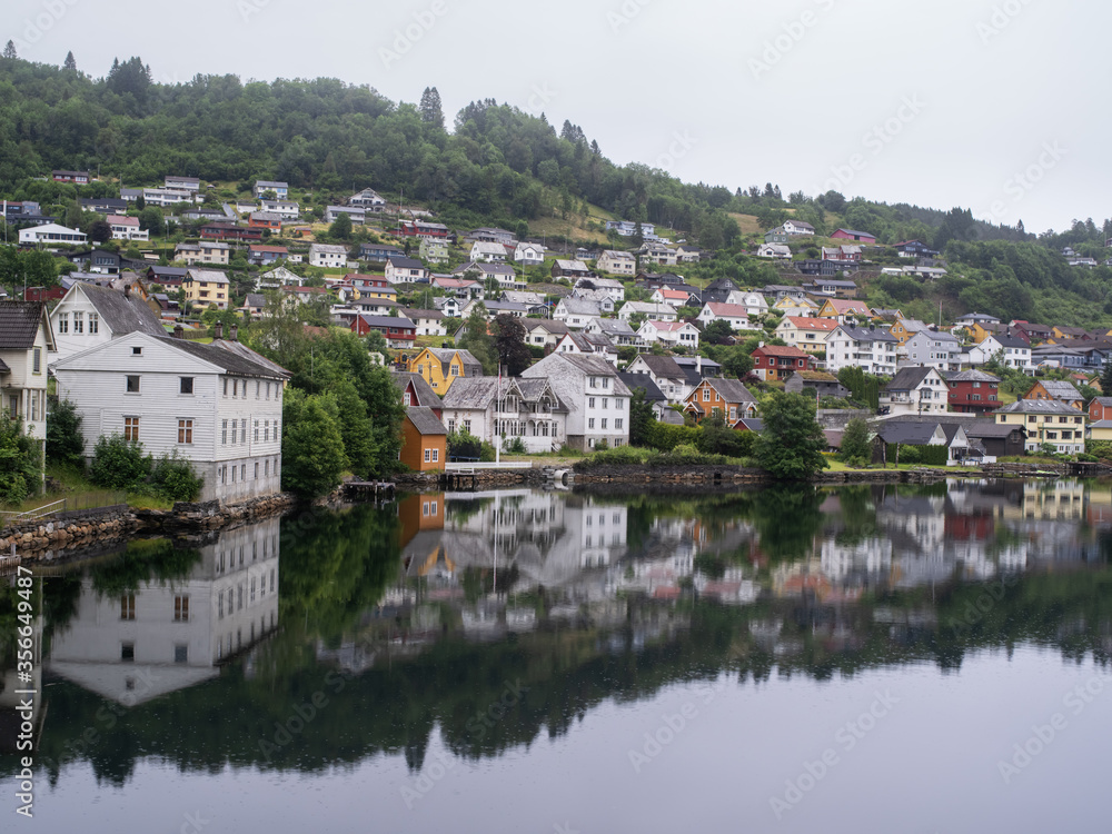 Cloudy summer view of Hardangerfjord and Norheimsund village, Norway, Europe