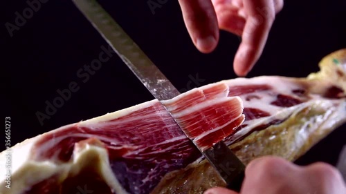 Cortando a la manera tradicional un jamón ibérico
 photo