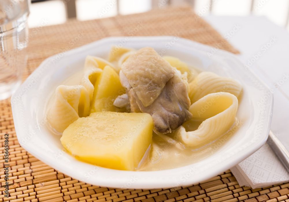 chicken broth soup with chicken, potatoes, and pasta shells chicken broth soup with chicken, potatoes, and pasta shells