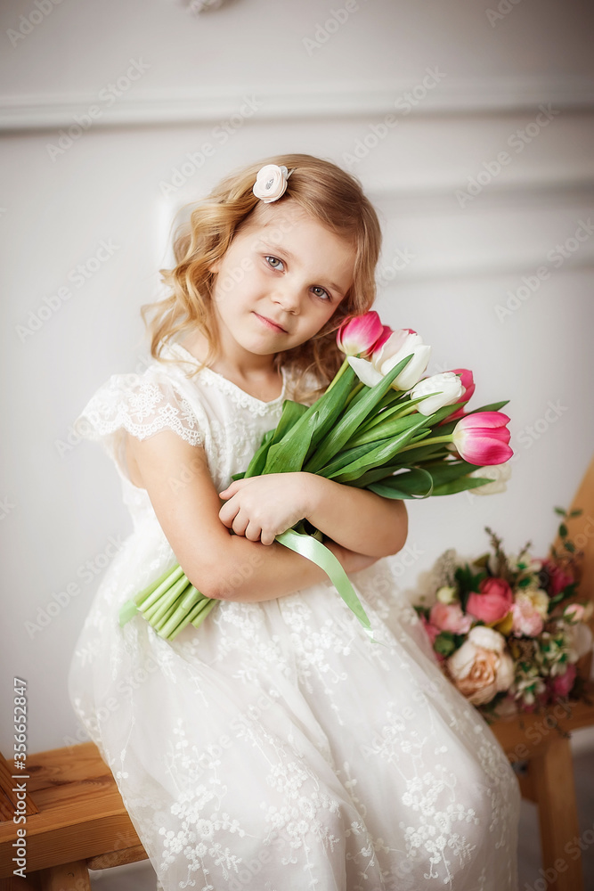 baby girl with tulips in a photo Studio, beautiful interior, spring, March baby girl with tulips in a photo Studio, beautiful interior, spring, March