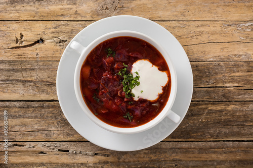 Traditional Ukrainian Russian borsch. Beetroot soup on wooden table. Top view