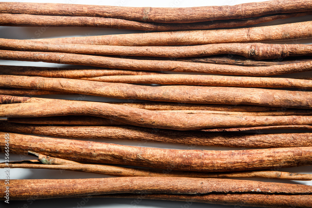 top view closeup group of dry cinnamon sticks served on white table surface top view closeup group of dry cinnamon sticks served on white table surface