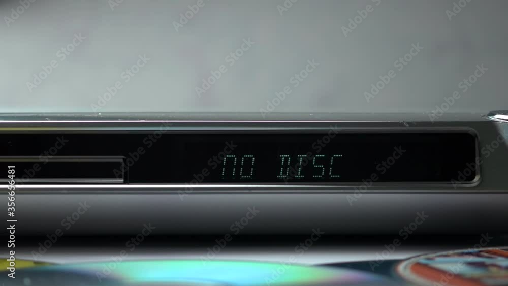 DVD Player Display. Eject Tray And Insert Disc In DVD-player. Male Hand Loading Disc Into The Device DVD/CD Player. . DVD Player Display. Eject Tray And Insert Disc In DVD-player. Male Hand Loading Disc Into The Device DVD/CD Player. .