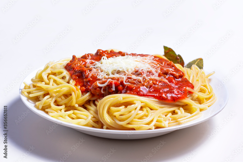 Delicious Spaguetti Pasta with bolognesa tomato sauce and chopped meat. Adorned with cheese and Laurel leaf Delicious Spaguetti Pasta with bolognesa tomato sauce and chopped meat. Adorned with cheese and Laurel leaf