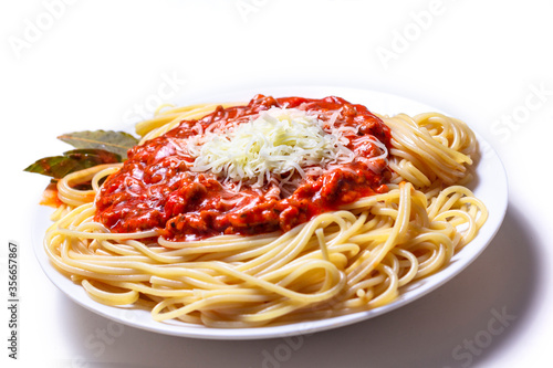 Delicious Spaguetti Pasta with bolognesa tomato sauce and chopped meat. Adorned with cheese and Laurel leaf