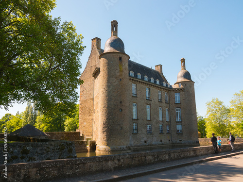 The castle of Flers, now a history museum (Normandy, Orne, France). Beautiful medieval architecture. Wide-angle shot of this historical monument. Surrounded by a moat. Cloudy day. 