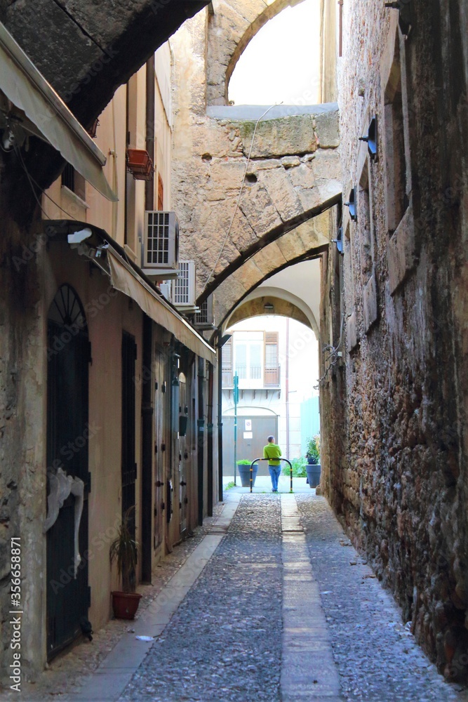 evocative image of an ancient street in the historic center of Palermo in Italy
