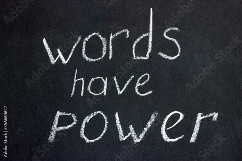  Words on a dark board with white chalk: "words have power." The slogan of freelancers and copywriters and not only