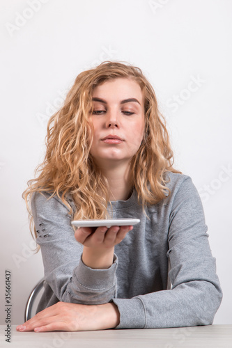 The girl holds a tablet on white background. Preparation for technology design.