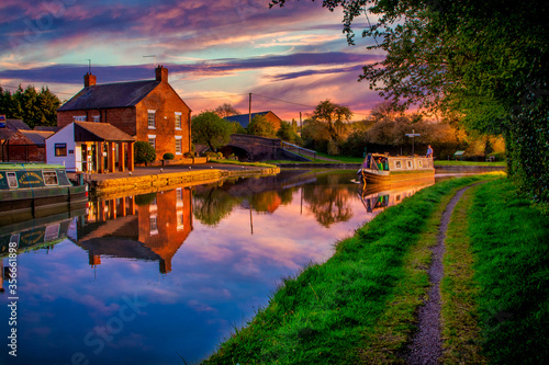 Fototapeta Narrow boat at sunset on the canal