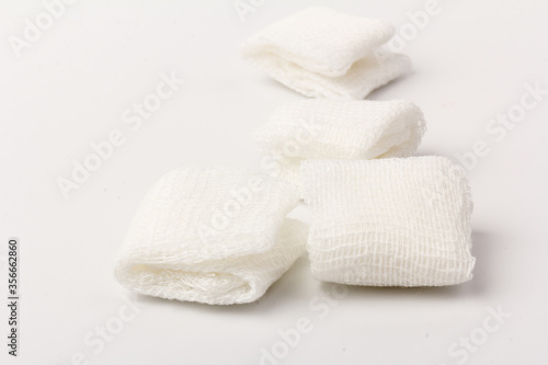 White gauze pads on white background. Materials for dental surgery. Close up