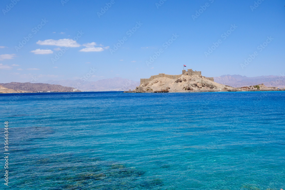 Egypt, Taba, Saladin castle, view from the sea, a fortress with towers and flag Egypt, Taba, Saladin castle, view from the sea, a fortress with towers and flag