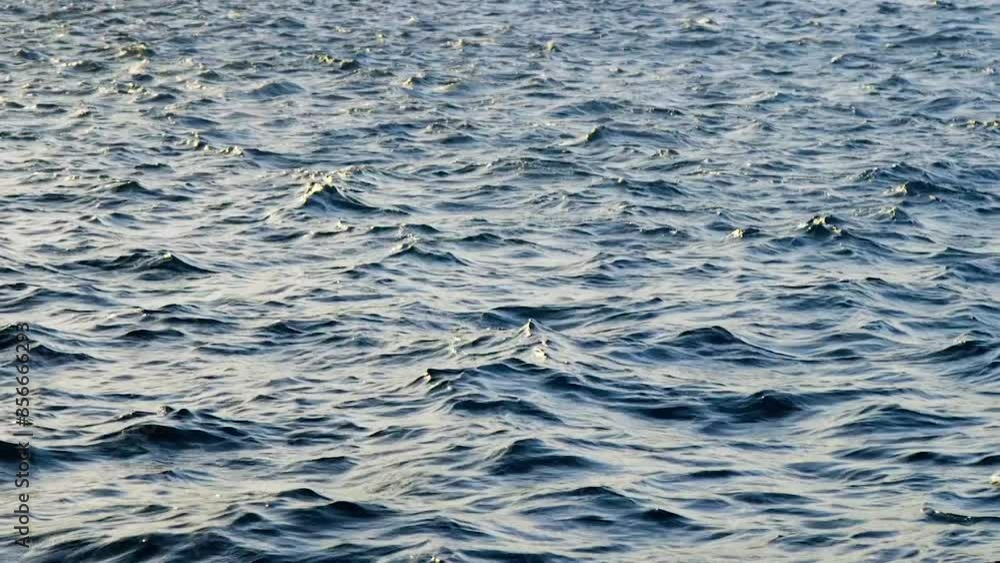 Sunlight Reflections On The Rippling Ocean Water During Sunset - close up Sunlight Reflections On The Rippling Ocean Water During Sunset - close up