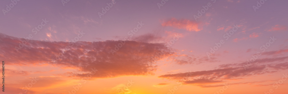 Fototapeta Cloudy sky at sunset or sunrise with sunlight. Abstract backdrop for design.