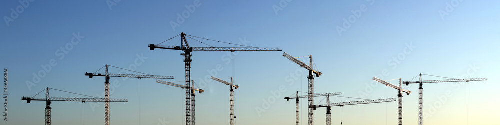 Wide-format panorama with construction cranes Wide-format panorama with construction cranes