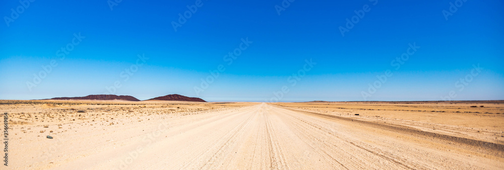 A gravel road in Namibia - obrazy, fototapety, plakaty 