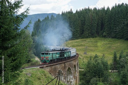 Russian train on a bridge in the forest in Ukraine. photo