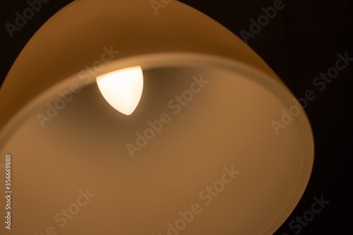 A round light lamp in a dark room