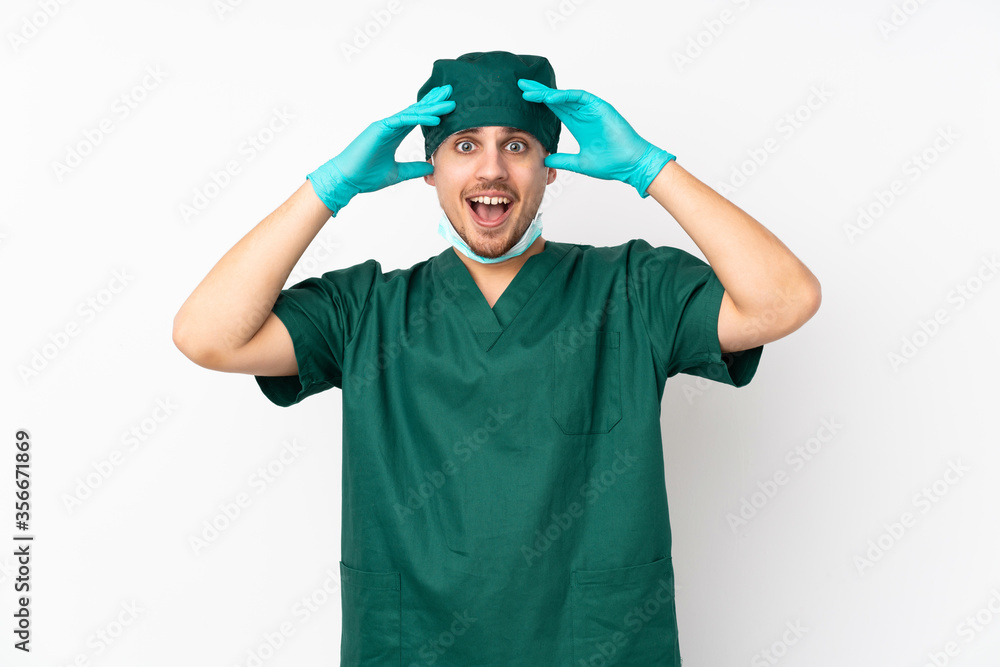 Surgeon in green uniform isolated on isolated white background with surprise expression Surgeon in green uniform isolated on isolated white background with surprise expression