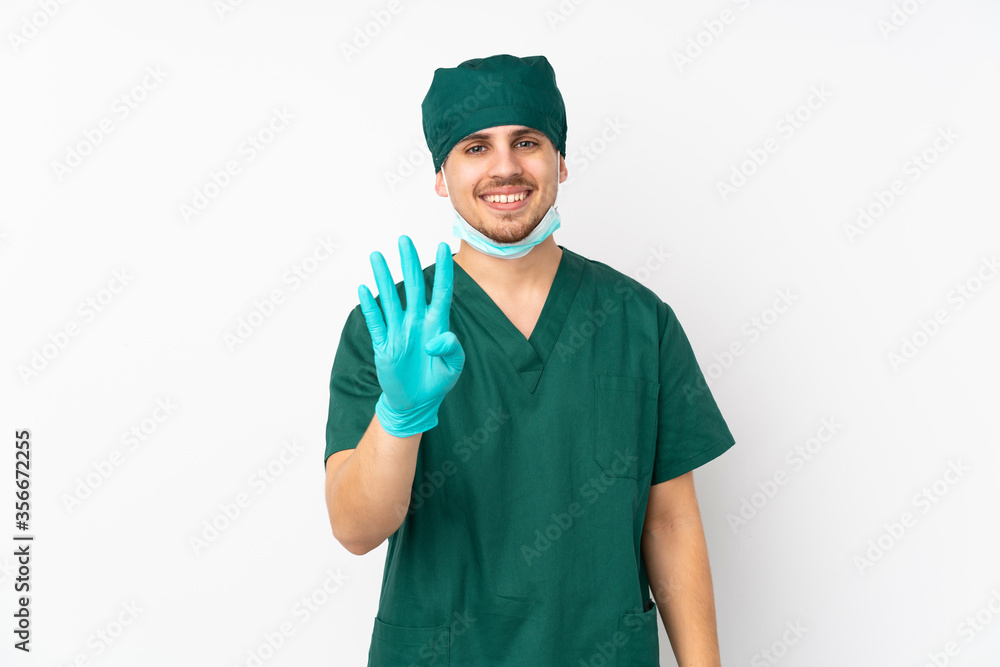 Surgeon in green uniform isolated on isolated white background happy and counting four with fingers Surgeon in green uniform isolated on isolated white background happy and counting four with fingers
