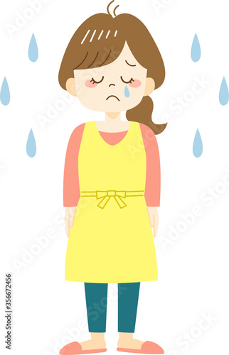 Crying young woman in yellow apron