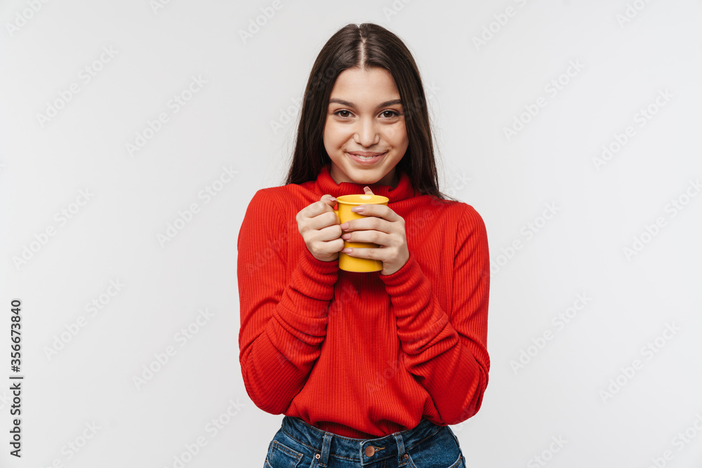 Photo of cheerful brunette woman smiling and holding cup