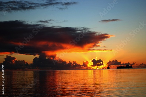 Gorgeous clouds and streaks of the setting sun in a tropical island