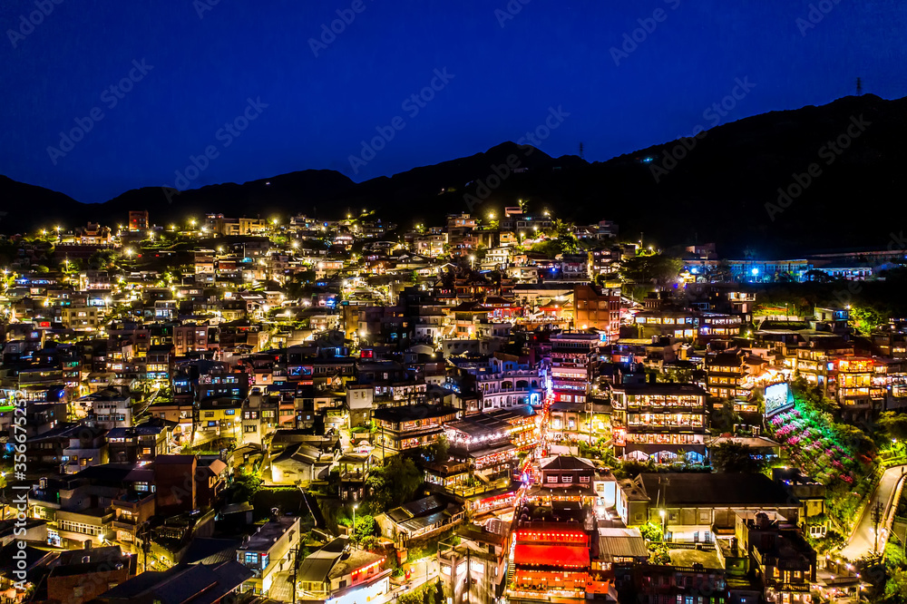 Fototapeta premium aerial view of night scene of Jioufen village, Taiwan. The colourful scene at night of Jiufen old city, Jiufen, Taiwan.