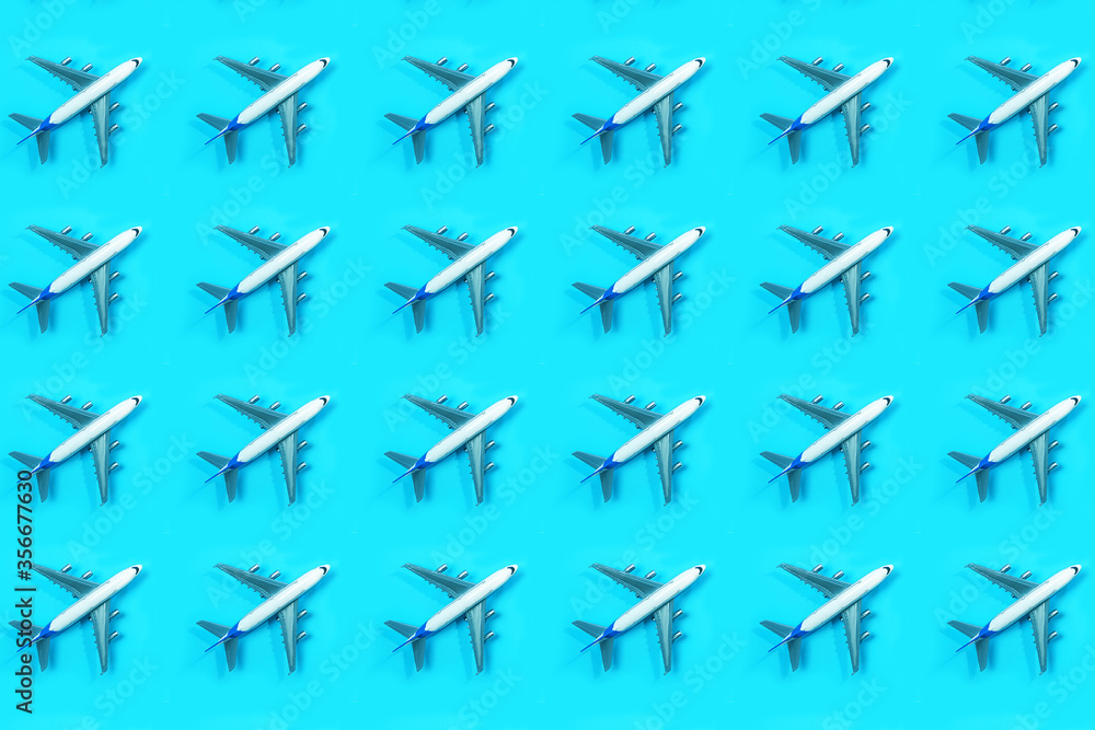Fototapeta premium Pattern made of model airplane on blue background.