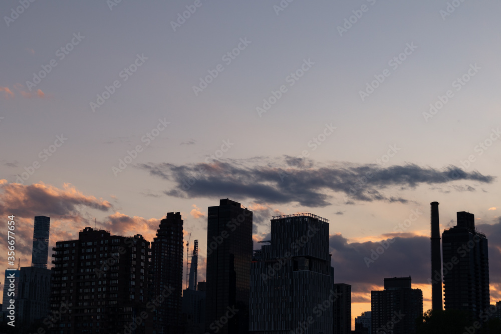 Manhattan and Roosevelt Island Skyline Silhouette during Sunset in New York City 