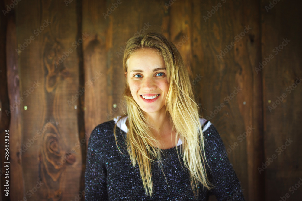 Young woman in front of wooden wall Young woman in front of wooden wall