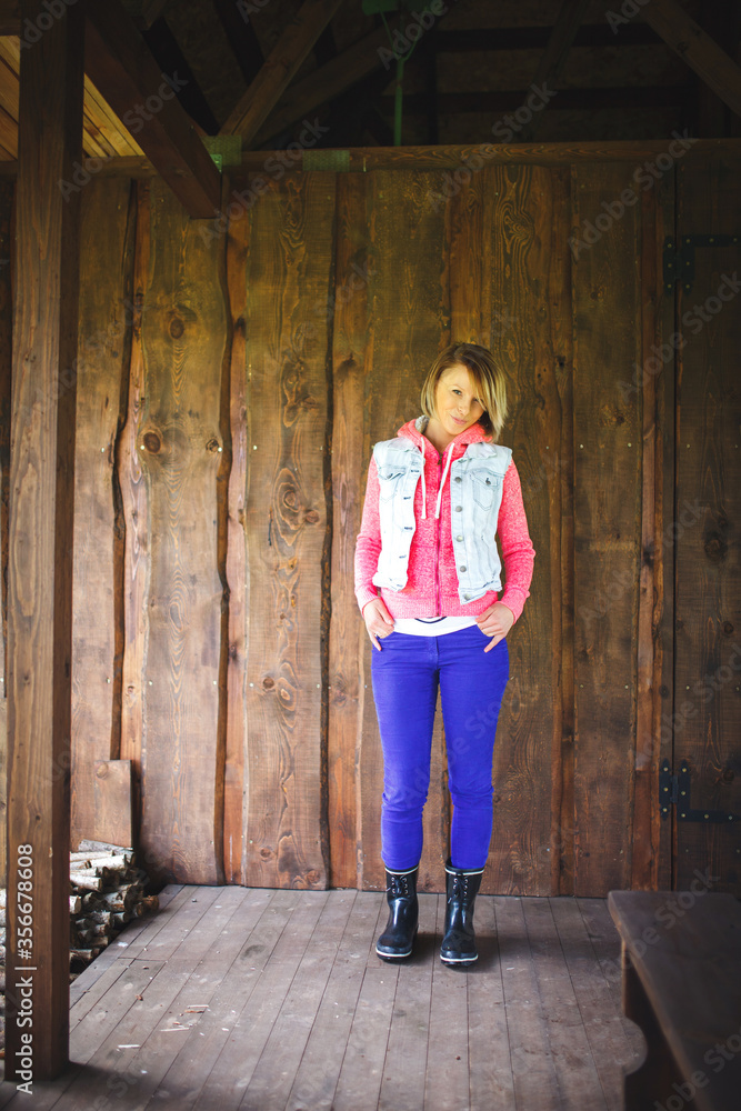 Young woman in front of wooden wall Young woman in front of wooden wall