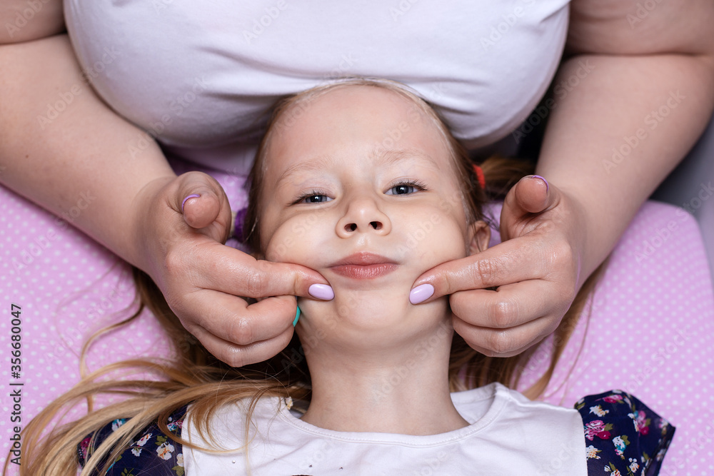 Little girl in class with a speech therapist . The use of special tools for speech correction. Little girl in class with a speech therapist . The use of special tools for speech correction.