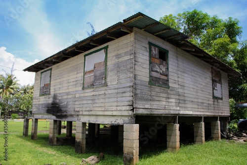 An abandoned house with hollow block stilts at the Inarajan Village in Guam, United States photo