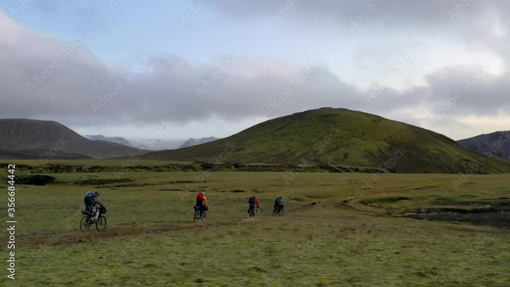 Amazing aerial drone shot of people riding on a path in Iceland Amazing aerial drone shot of people riding on a path in Iceland
