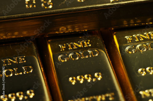 close up shot of stacked 999.9 pure gold bar ingot on a black background, represented the business, invesment and finance concept idea