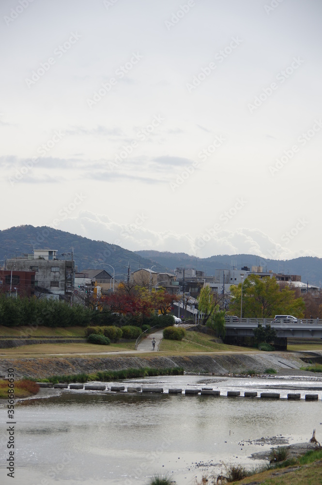 Stone path and bridge crossing Kamo River in Kyoto