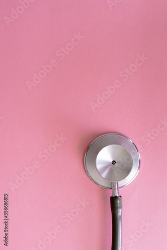 Top view of stethoscope on pink background for coronavirus prevention. Covid-19 kit. Copy Space. Medical concept. © EGHStock