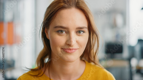Portrait of Beautiful Young Woman with Red Hair Wearing Yellow Sweater Looking Up to the Camera and Smiling Charmingly. Successful Woman Working in Bright Diverse Office. Free Download Portrait of Beautiful Young Woman with Red Hair Wearing Yellow Sweater Looking Up to the Camera and Smiling Charmingly. Successful Woman Working in Bright Diverse Office. - GFXLoad