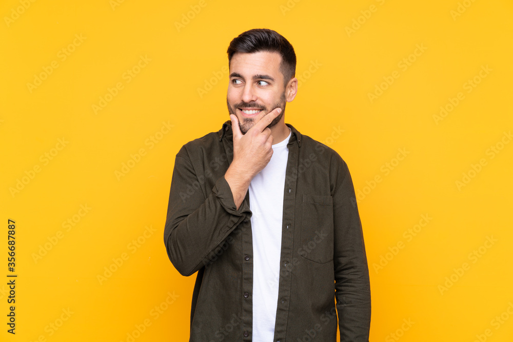 Man over isolated yellow background thinking an idea Man over isolated yellow background thinking an idea