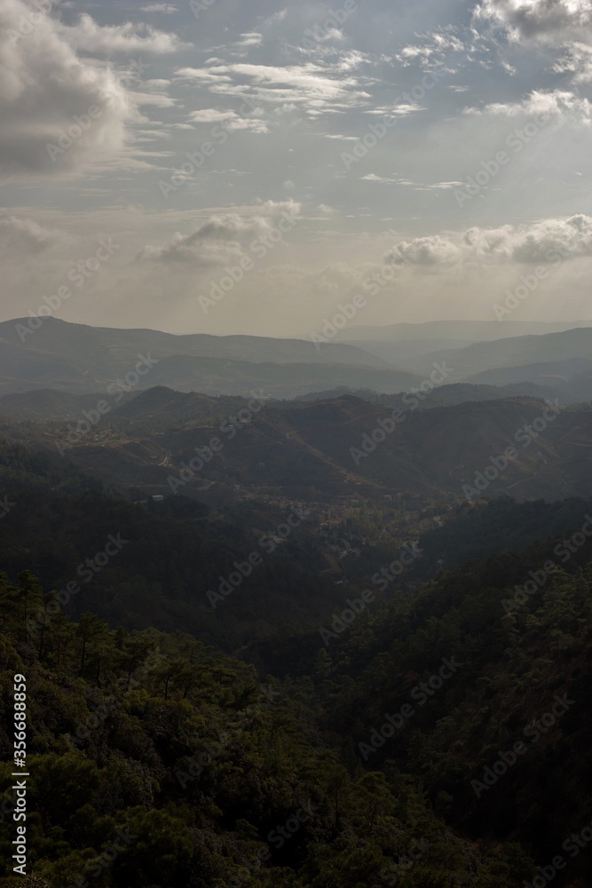 Scenic view of mountains with lush forests on sunny day