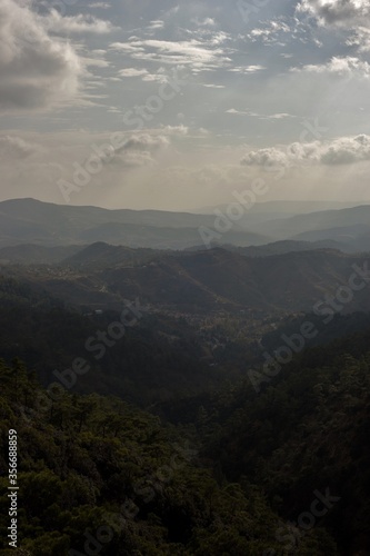 Scenic view of mountains with lush forests on sunny day