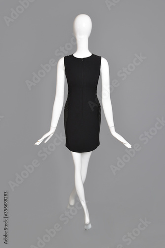 lifeless mannequin with black clothes isolated grey background studio